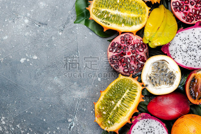 热带和异国水果边界背景。在混凝土背景下的新鲜生水果
