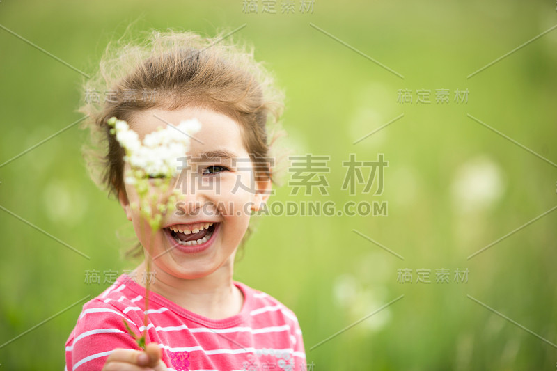 一个可爱的女孩在田野里与野花的肖像。童年，乡村假期，自由和粗心。夏天的时间。国际儿童日”。驱蚊剂，小