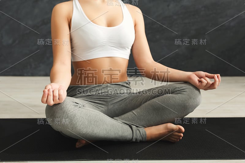 Unrecognizable woman training yoga in lotus pose