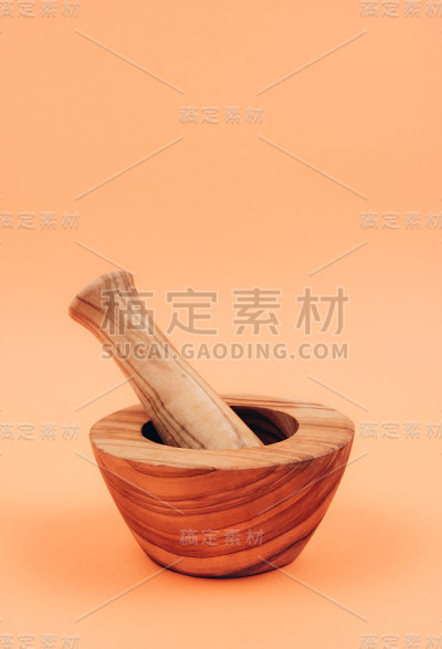 木质香料研钵，杵柄，橙色背景。
