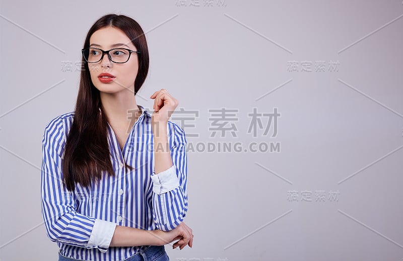 一个可爱的年轻女商人站在后面，看着一边