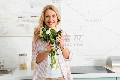 幸福的女人在家里捧着一束郁金香