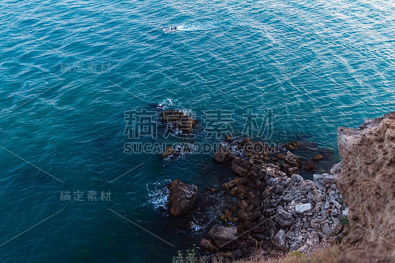 View from altitude on high cliff on the blue sea w