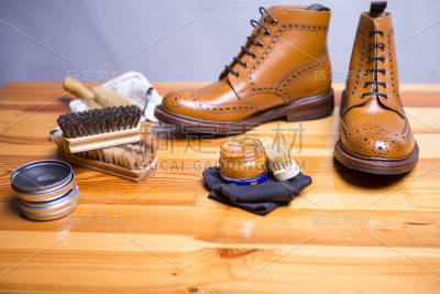 鞋的想法和概念。特写Premium Tan Brogue皮靴与清洁配件，蜡，布。水平方向