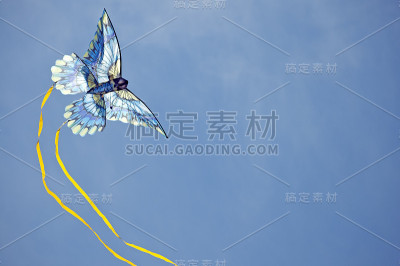 蓝色的风筝在天空中划出一道弧线