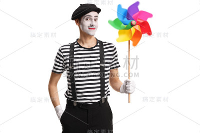 哑剧手拿一个旋转的风车玩具