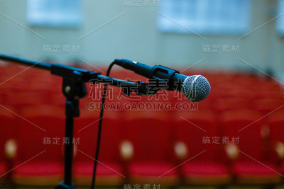 麦克风越过抽象模糊的会议厅或会议室背景