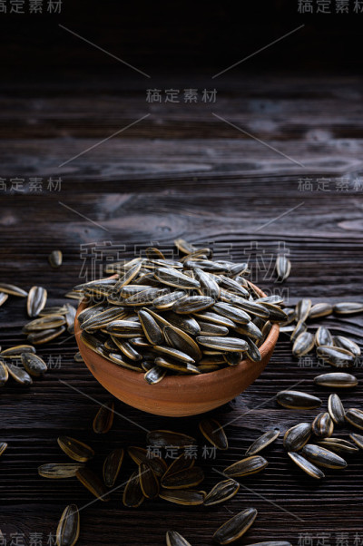 葵花籽在碗上的木材背景