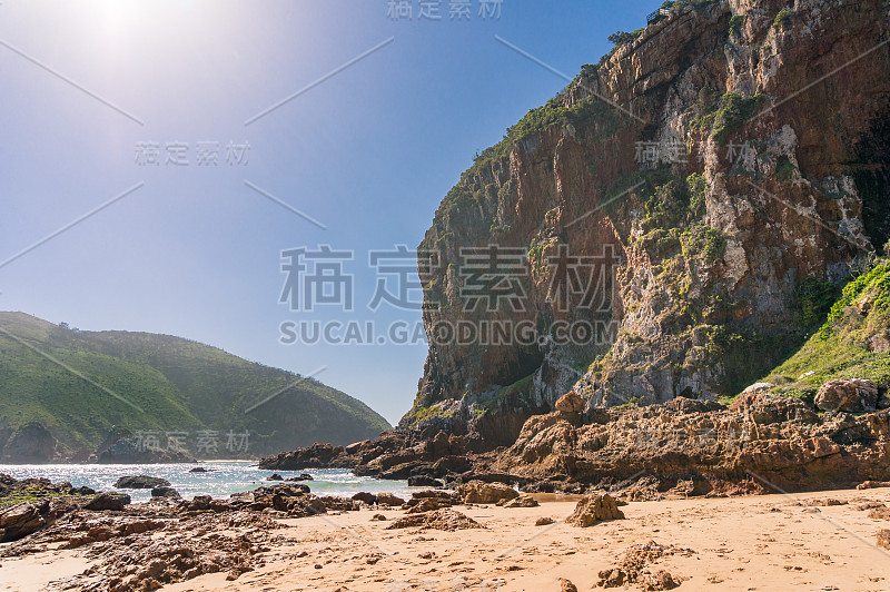 巨大的岩石悬崖山和绿色的山丘在阳光灿烂的日子