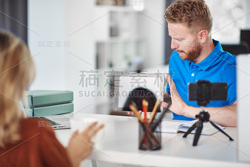 英俊的白种人专注员工拿着平板电脑，试图说服女性客户购买股票。