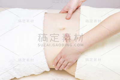 按摩治疗师按摩一个女人的胃。按摩和身体护理。水疗身体按摩女人的双手治疗。
