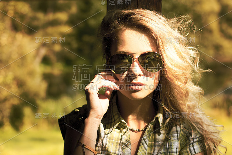 戴着太阳镜的金发女人的肖像