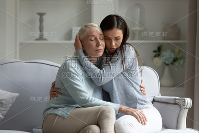 爱的成年女儿拥抱安慰不安成熟的妈妈