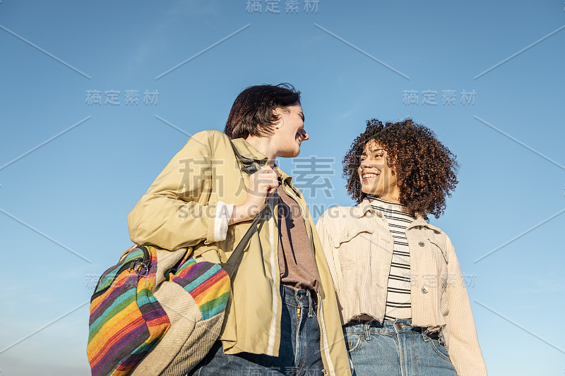 两个年轻女子微笑着互相看了看