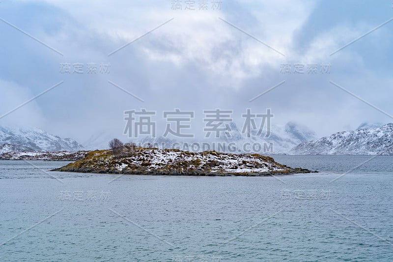 罗浮敦群岛，北欧郡，挪威，欧洲。白雪皑皑的山峦和树木，是冬季自然景观的背景。著名的旅游景点