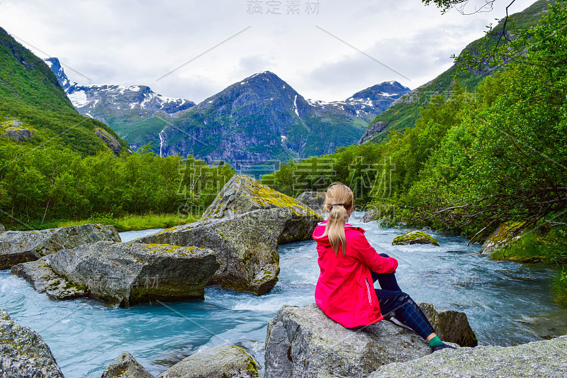 The young woman near the river which is located ne