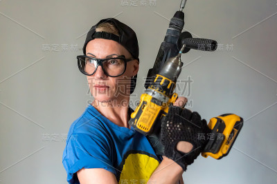 一个手里拿着钻头的女建筑工人